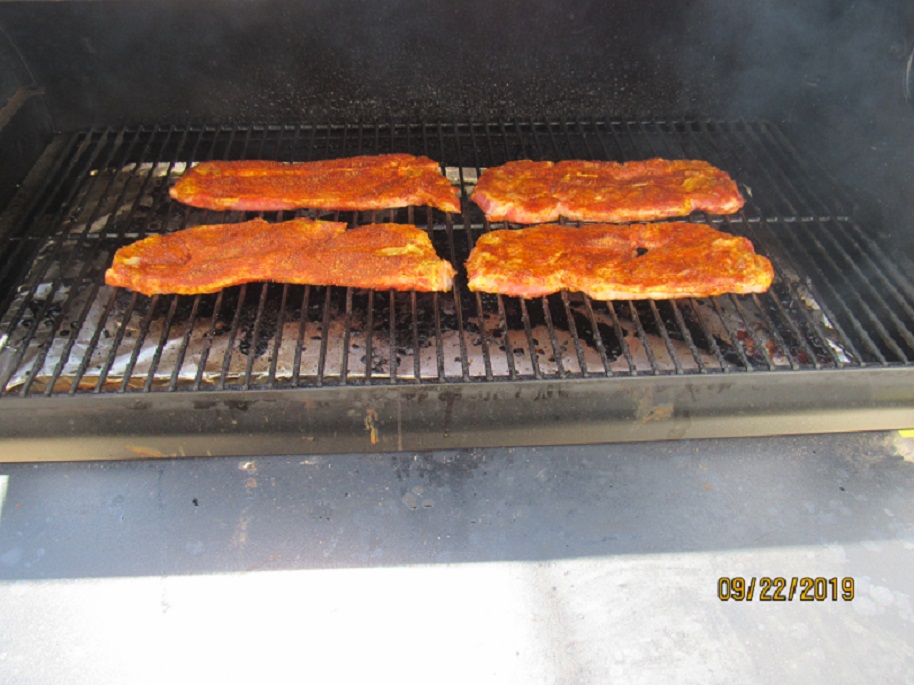 Pork steaks on the smoker.JPG